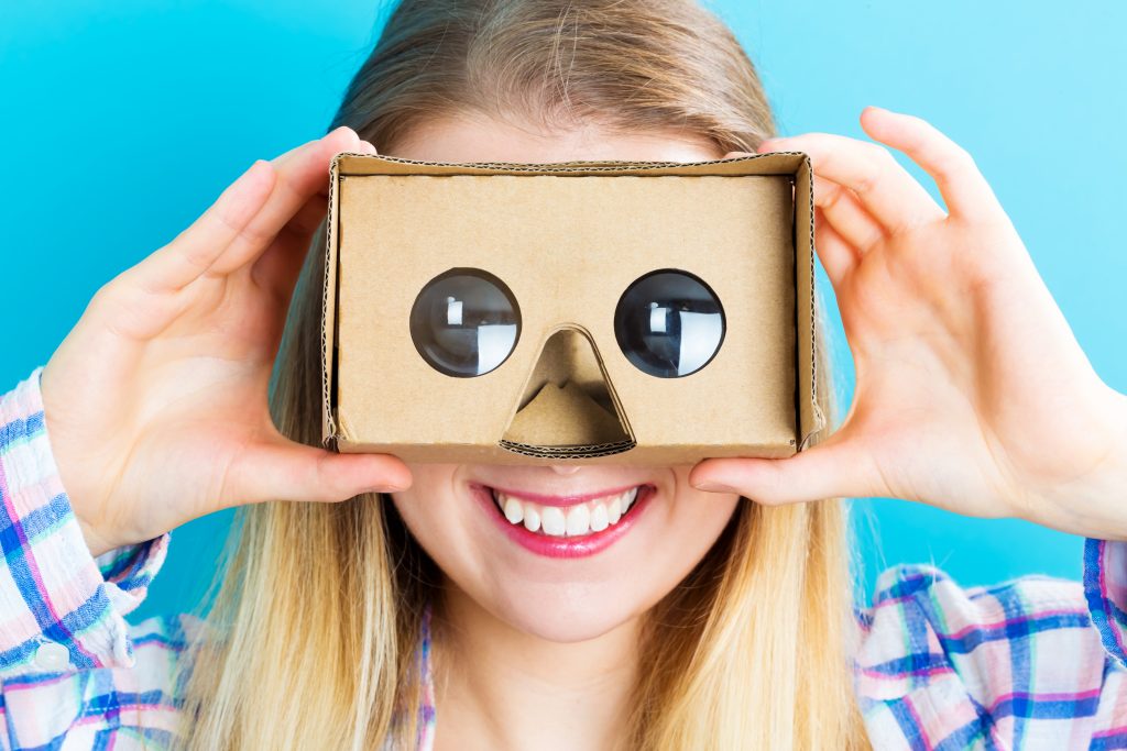 happy young woman using a virtual reality headset SBI 317521667